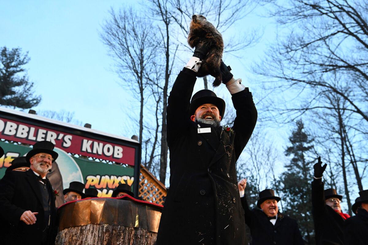 Groundhog Club handler A.J. Dereume holds Punxsutawney Phil, the weather prognosticating groundhog, during the 136th celebration of Groundhog Day on Gobbler's Knob in Punxsutawney, Pa., on Feb. 2, 2022. (Barry Reeger/AP Photo)