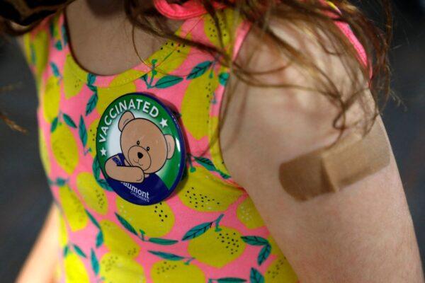 A child wears a pin she received after receiving her first dose of the Pfizer Covid-19 vaccine at the Beaumont Health offices in Southfield, Michigan on Nov. 5, 2021. (Jeff Kowalsky/AFP via Getty Images)