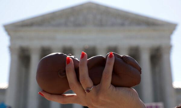 A pro-life activist holds a model fetus during a demonstration in front of the U.S. Supreme Court in Washington, D.C., on June 29, 2020. (Alex Wong/Getty Images)