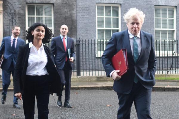 UK Prime Minister Boris Johnson leaves Downing Street with political adviser Munira Mirza (L) for a Cabinet meeting at the Foreign Office in London on Dec. 15, 2020. (Peter Summers/Getty Images)