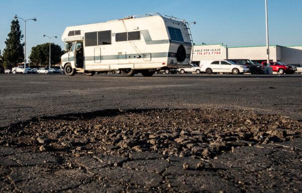 An RV stops near a pothole-filled parking area in Fullerton, Calif., on Dec. 14, 2020. (John Fredricks/The Epoch Times)