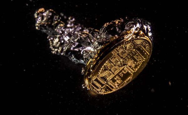 A visual representation of digital currency sinking in water. (Dan Kitwood/Getty Images)