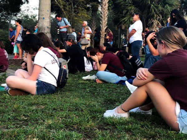 People attend a spiritual service in Pine Trails Park with leaders of several faiths in tribute to the victims of the Marjory Stoneman Douglas High School shooting in Parkland, Fla., on Feb. 14, 2020. (Leila Macor/AFP via Getty Images)