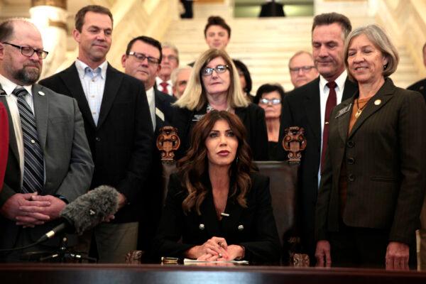 South Dakota Gov. Kristi Noem signs the "Protect Fairness in Women's Sports" bill at the state Capitol in Pierre, S.D., on Feb. 3, 2022. (Stephen Groves/AP Photo)