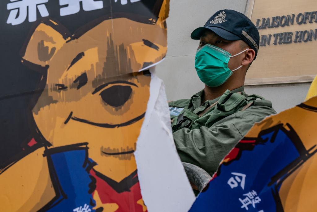 A placard of Winnie the Pooh representing Xi Jinping is torn up by protesters during a rally outside of the Chineses Liaison Office in Hong Kong, China, on May 24, 2020. (Anthony Kwan/Getty Images)