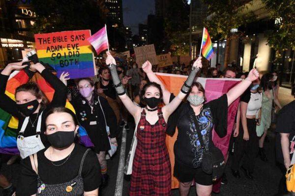 Supporters and members of the LGBTQI+ community are seen protesting against Citipointe Christian College during a rally in King George Square in Brisbane, Friday, Feb. 4, 2022. (AAP Image/Darren England)