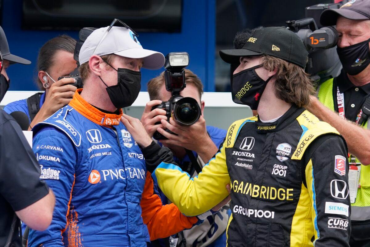 Scott Dixon of New Zealand (L) talks with Colton Herta after Dixon won the pole for the Indianapolis 500 auto race at Indianapolis Motor Speedway in Indianapolis on May 23, 2021. (Darron Cummings/AP Photo)