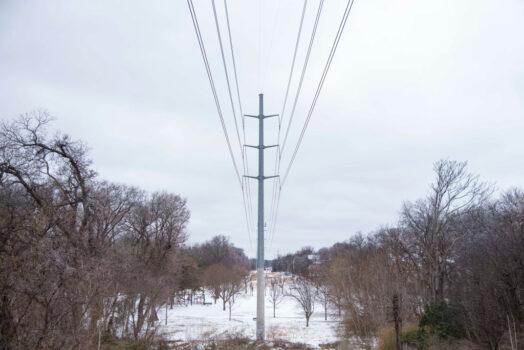 Snow lies on the ground near power lines at White Rock Lake after a winter storm on Feb. 3, 2022, in Dallas. (Emil Lippe/Getty Images)