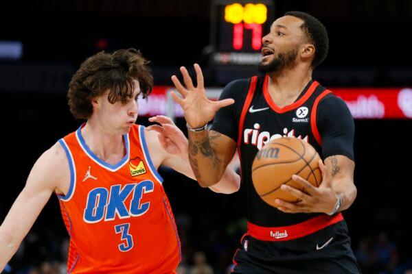 Portland Trail Blazers forward Norman Powell, right, keeps the ball away from Oklahoma City Thunder guard Josh Giddey in the first half of an NBA basketball game, in Oklahoma City, on Jan. 31, 2022. (Nate Billings/AP Photo)