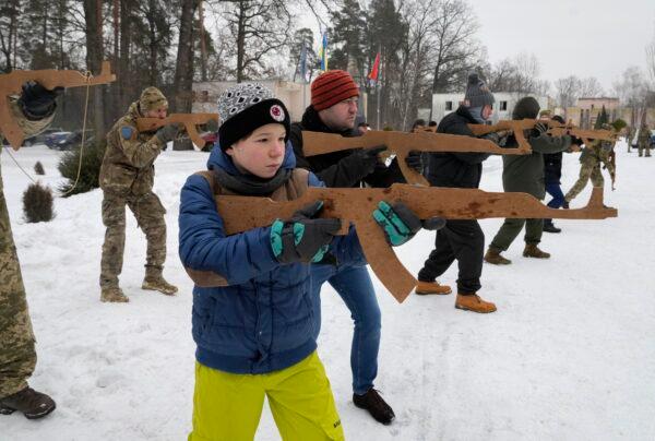 Yuri, 12, trains with members of Ukraine's Territorial Defense Forces, volunteer military units of the Armed Forces, close to Kyiv, Ukraine, on Feb. 5, 2022. (Efrem Lukatsky/AP Photo)