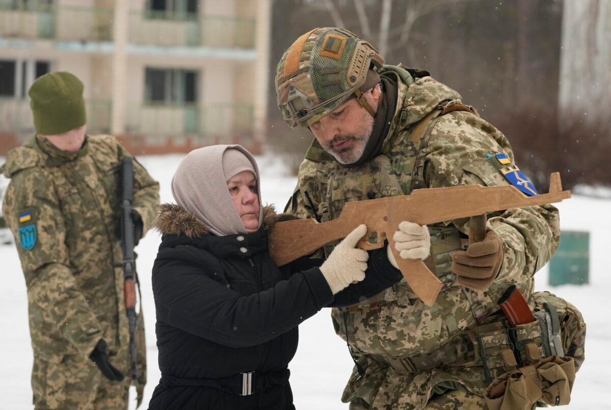An instructor trains Rumia, 59, a member of Ukraine's Territorial Defense Forces, close to Kyiv, Ukraine, on Feb. 5, 2022. (Efrem Lukatsky/AP Photo)