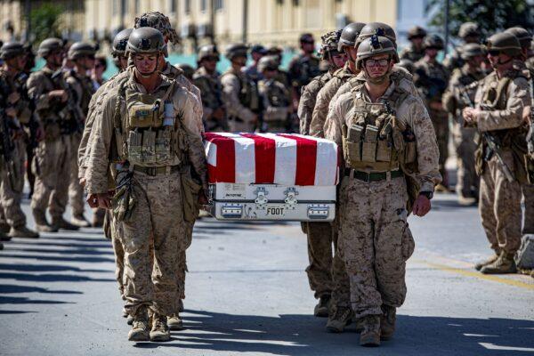 U.S. Marines carry the remains of 13 comrades killed during the terrorist attack at Hamid Karzai International Airport in Kabul, Afghanistan, on Aug. 26, 2021. (U.S. Marine Corps/1st Lt. Mark Andries via Reuters)