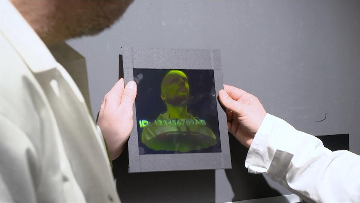 Researchers holding a holographic image of a person at a lab in Vac, Hungary, on Jan. 28, 2022, in a still from a video. (AP/Screenshot via The Epoch Times)