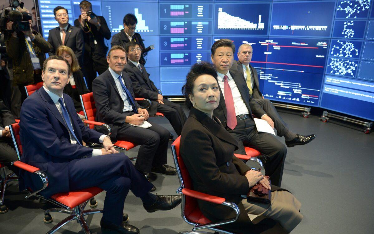 Britain’s then chancellor George Osborne (left), Madame Peng Liyuan (second left), Chinese leader Xi Jinping (center), and Prince Andrew, Duke of York (second right) listen to Professor Yike Guo (not pictured) during a visit to Imperial College London on Oct. 21, 2015. (Anthony Devlin/WPA Pool /Getty Images)