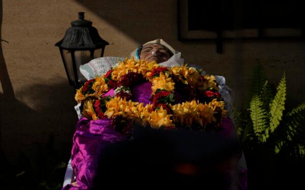 The body of Lata Mangeshkar, lies as people pay tribute outside her home in Mumbai, India, Feb.6, 2022. (Rafiq Maqbool/AP Photo)