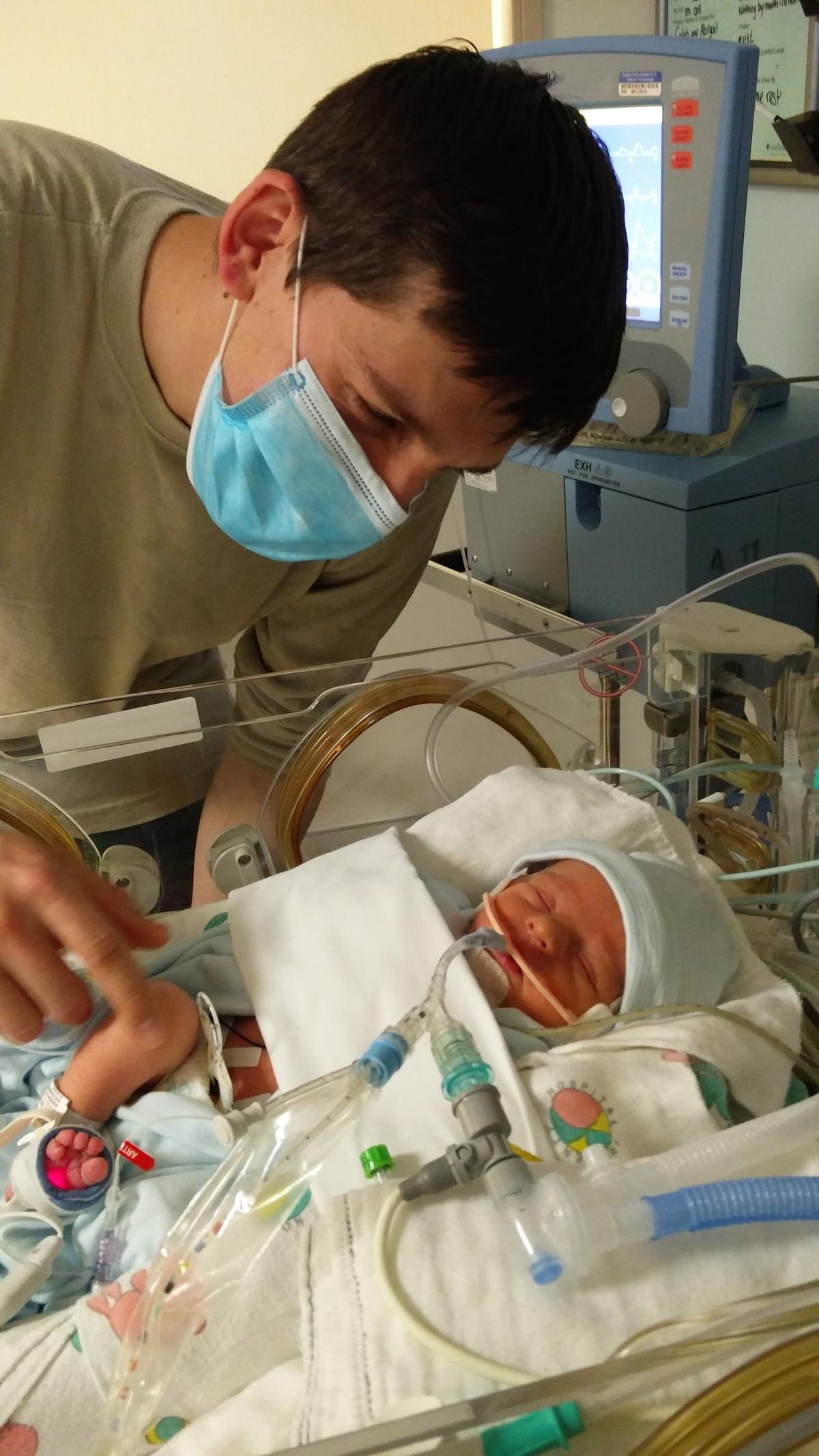 Caleb with newborn baby Theodore. (Courtesy of Abigail Ostrom)