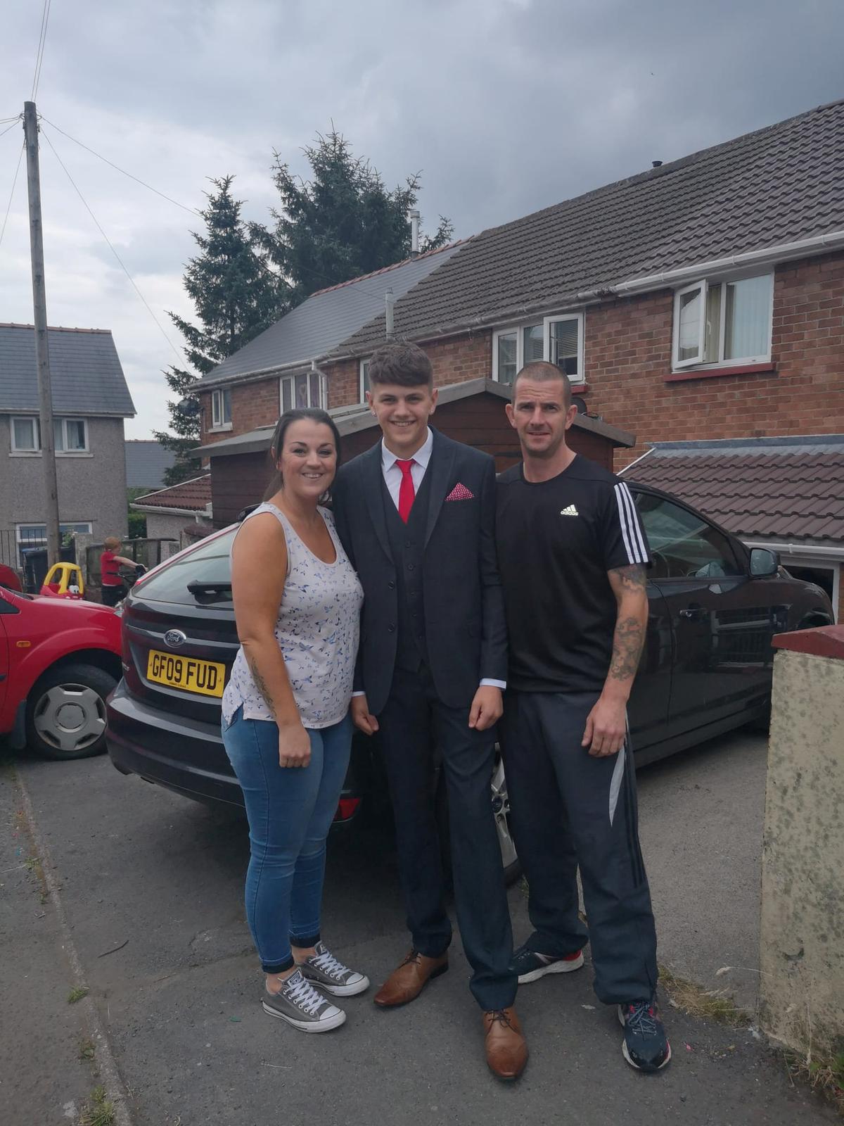 Rhys Langford with mom Catherine and dad Paul. (SWNS)