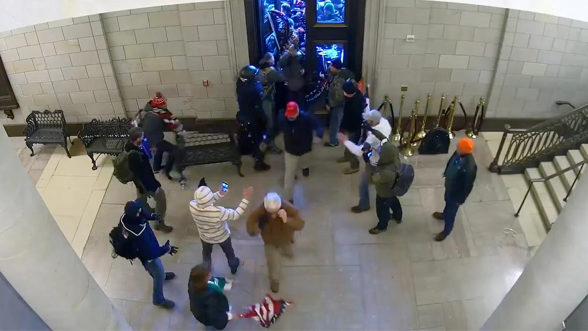 People flow into the Capitol Rotunda after being let in by a protester, shown on this surveillance video from Jan. 6, 2021. (Video Still/U.S. Department of Justice)