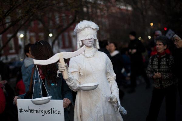 A woman dressed as Lady Justice attends a rally to mark International Women's Day in Washington Square Park, New York City, on March 8, 2017. (Drew Angerer/Getty Images)