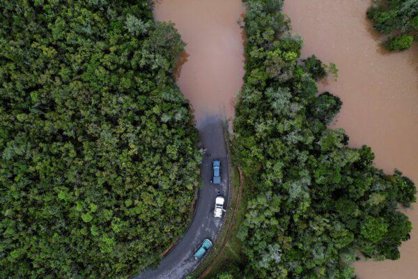 Cars stop before a flooded area, after Cyclone Batsirai made landfall, on a road in Vohiparara, Madagascar, on Feb. 6, 2022. Picture was taken with a drone. (Christophe Van Der Perre TPX Images of the Day/Reuters)