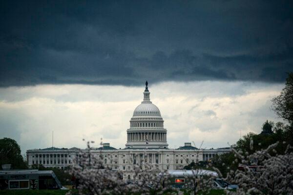 In a file photo, clouds form above the U.S. Capitol in between rain showers on the National Mall on March 28, 2021 in Washington, DC. (Al Drago/Getty Images)