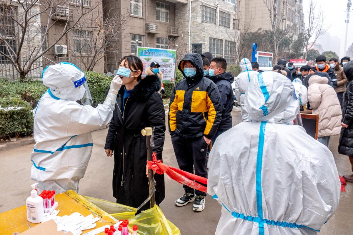 A resident undergoes a nucleic acid test for COVID-19 in Anyang in central China's Henan Province on Jan. 26, 2022. (STR/AFP via Getty Images)