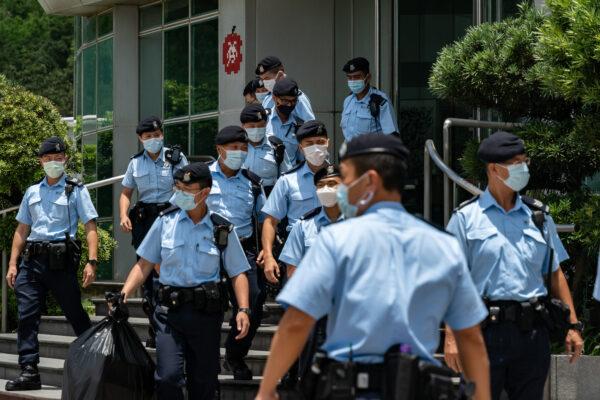Police carry evidence they seized from the headquarters of the Apple Daily newspaper and its publisher, Next Digital Ltd., on June 17, 2021, in Hong Kong, China. (Anthony Kwan/Getty Images)