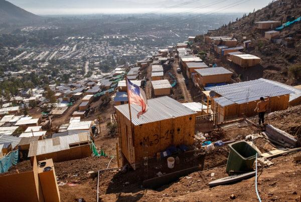 The Chilean flag flies over a mountainside squatter camp built by Haitian and Peruvian immigrants on Nov. 21, 2021 in Lampa, Chile. (John Moore/Getty Images)
