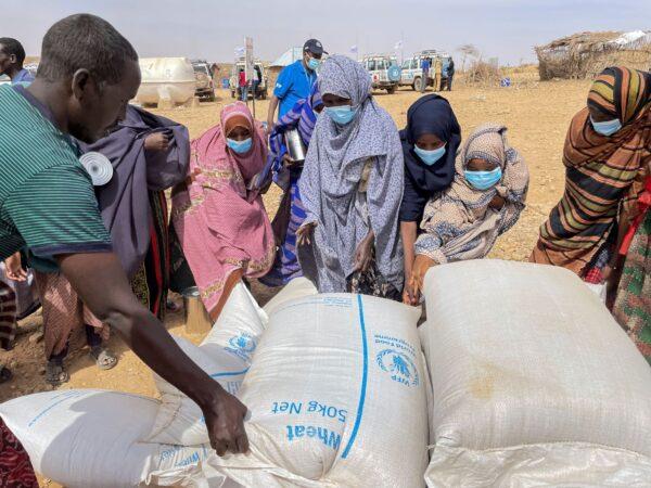 Food supplies of wheat are distributed during a visit by World Food Programme (WFP) Regional Director Michael Dunford to a camp for the internally-displaced in Adadle, in the Somali Region of Ethiopia, on Jan. 22, 2022. (Claire Nevill/WFP via AP)