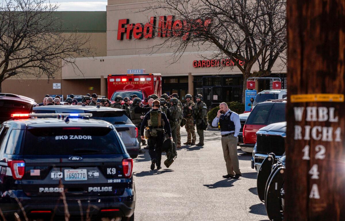 Authorities stage outside a Fred Meyer grocery store after a fatal shooting at the business on Wellsian Way in Richland, Wash., on Feb. 7, 2022. (Jennifer King/The News Tribune via AP)