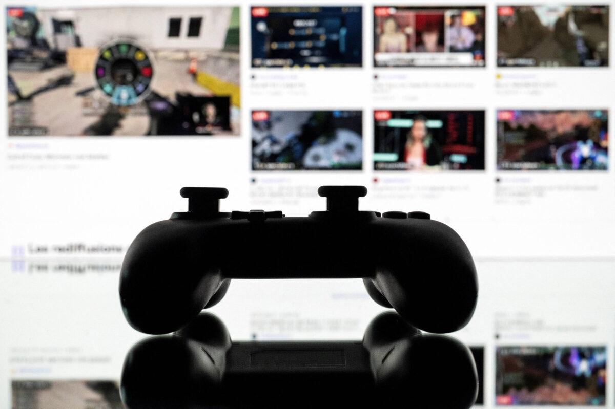 A gamepad is pictured as a screen that displays the online Twitch platform in Toulouse, France, on June 15, 2021. (Lionel Bonaventure/AFP via Getty Images)