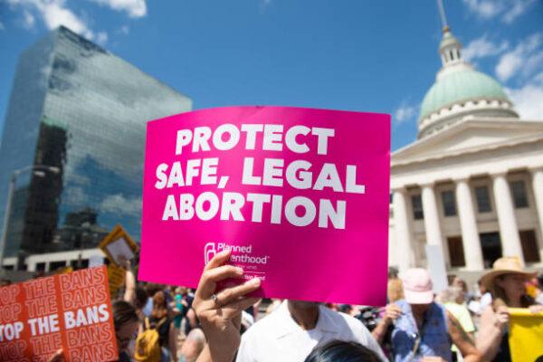 Protesters hold signs as they rally in support of Planned Parenthood and to protest a state decision that would effectively halt abortions by revoking the center's license to perform the procedure, near the Old Courthouse in St. Louis, Missouri, May 30, 2019. (Saul Loeb/AFP via Getty Images)