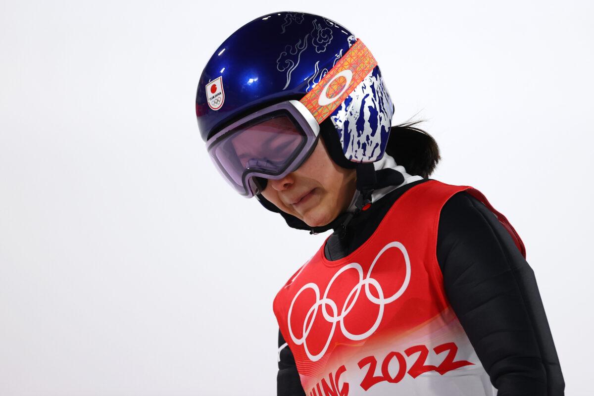 Sara Takanashi of Team Japan shows dejection after being disqualified after jumping in Mixed Team Ski Jumping Final Round at National Ski Jumping Center in Zhangjiakou, China, on Feb. 07, 2022. (Cameron Spencer/Getty Images)