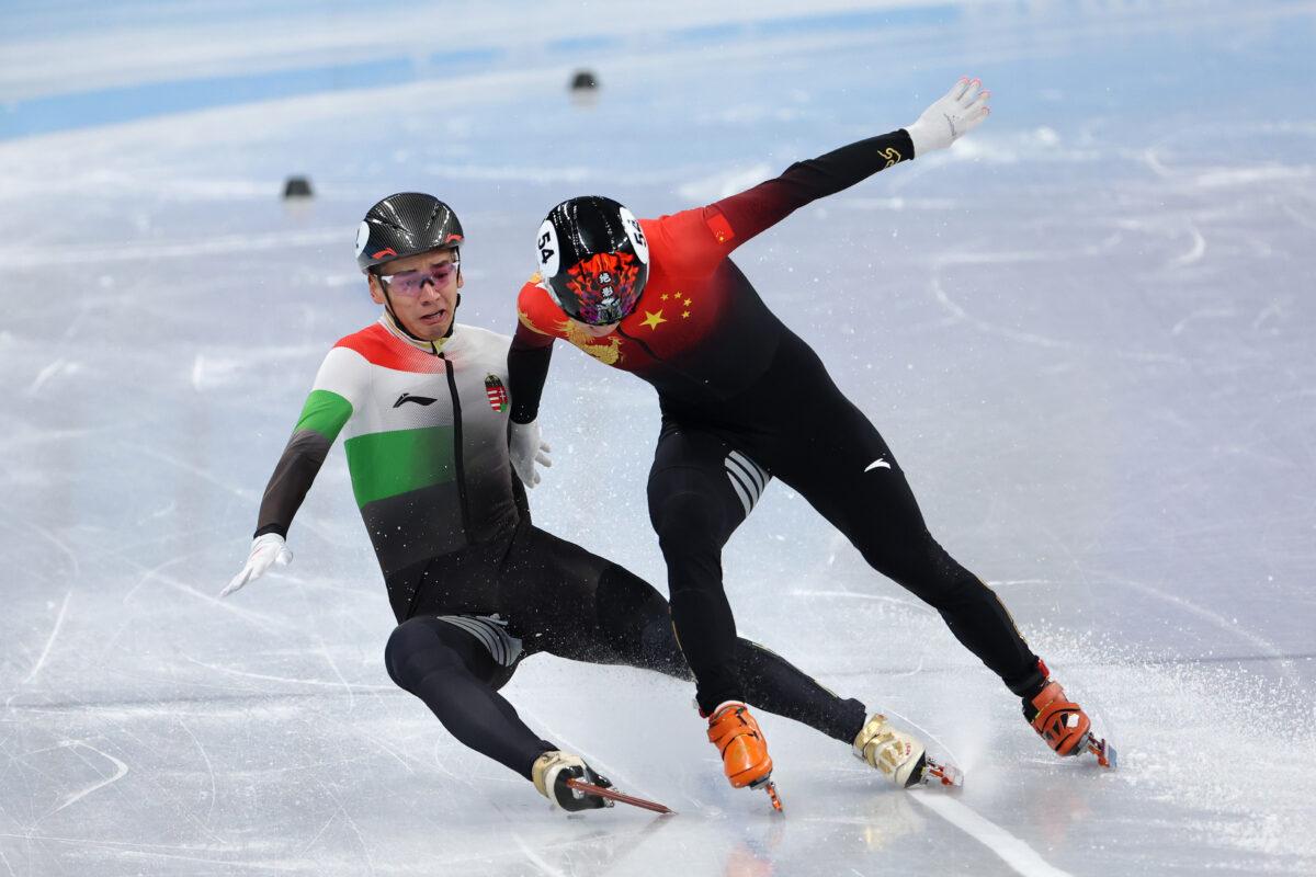 Ren Ziwei of Team China and Shaolin Liu of Team Hungary collide as they cross the finish line during the Men's 1,000-meter Final A on day three of the Beijing 2022 Winter Olympic Games at Capital Indoor Stadium on Feb. 07, 2022. (Lintao Zhang/Getty Images)