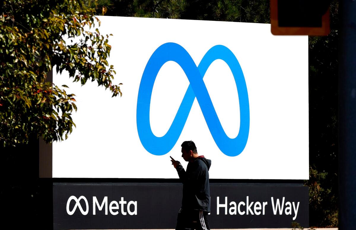 A pedestrian walks in front of the new Meta logo in front of Facebook headquarters in Menlo Park, Calif., on Oct. 28, 2021. (Justin Sullivan/Getty Images)