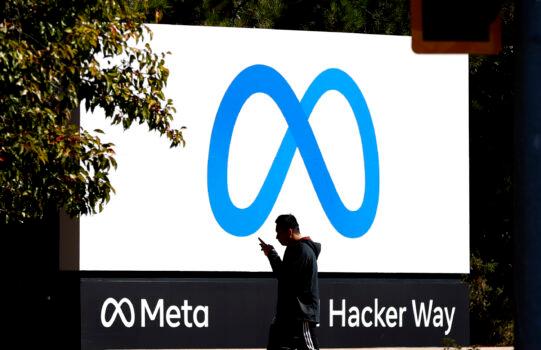 A pedestrian walks in front of the new 'Meta' logo in front of Facebook headquarters in Menlo Park, Calif., on Oct. 28, 2021. (Justin Sullivan/Getty Images)