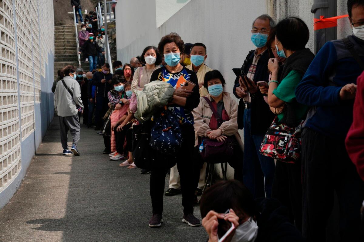 Residents line up to get tested for the coronavirus at a temporary testing center for COVID-19, in Hong Kong on Feb. 15, 2022. (Kin Cheung/AP Photo)