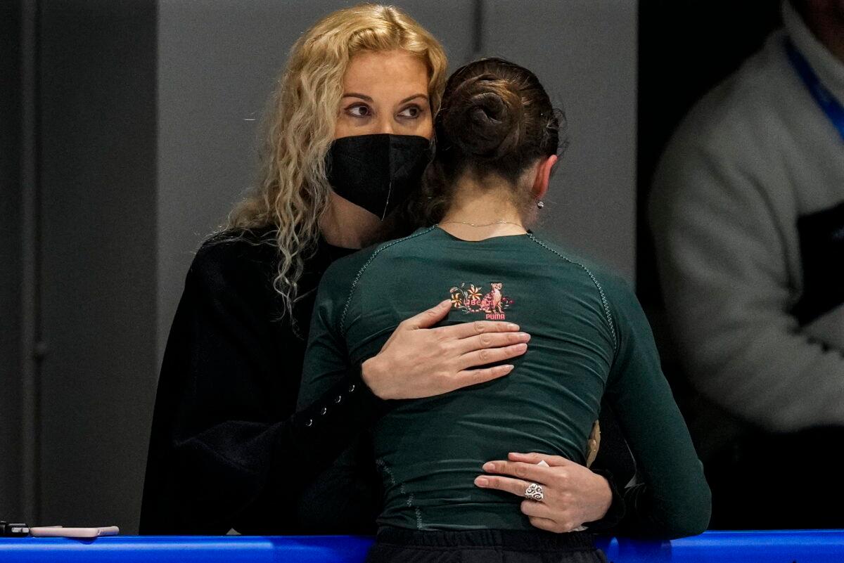 Coach Eteri Tutberidze (L) embraces Kamila Valieva, of the Russian Olympic Committee, during a training session at the 2022 Winter Olympics, in Beijing, on Feb. 12, 2022. (Bernat Armangue/AP Photo)