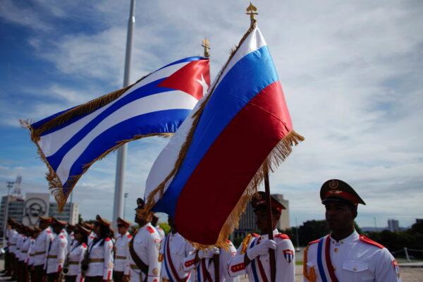 Honor guards hold Russian and Cuban flags during a wreath-laying ceremony at the Jose Marti monument in Havana, Cuba, Oct. 3, 2019. (Reuters/Alexandre Meneghini)