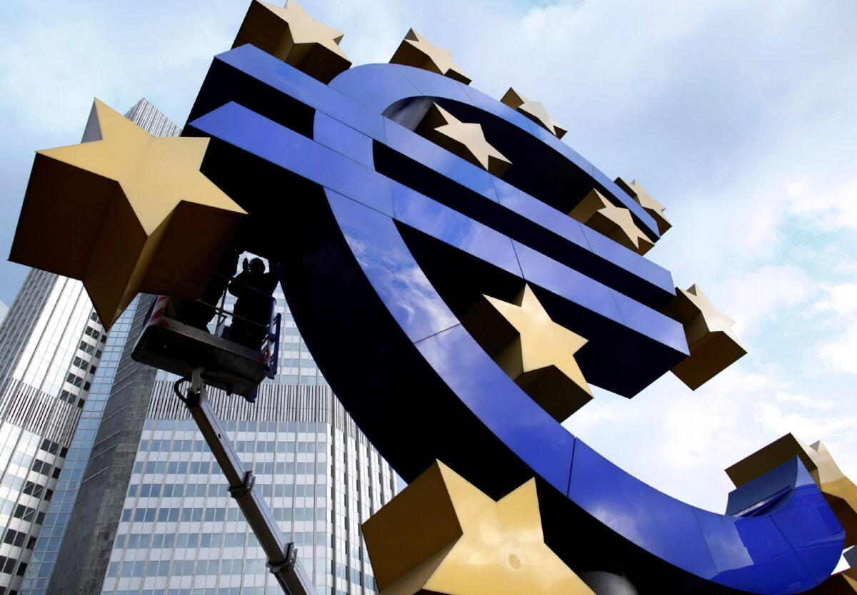 Workers maintain the huge Euro logo in front of the headquarters of the European Central Bank (ECB) in Frankfurt, Germany, on Dec. 6, 2011. (Ralph Orlowski/Reuters)