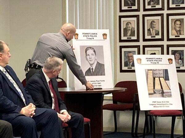 Trooper Anthony Petroski, (R), unveils a poster with a high school yearbook image of James Paul Forte, beside another photo showing the Police case file for Marise Ann Chiverella at a news conference in Hazleton, Pa., on Feb. 10, 2022. (Michael Rubinkam/AP Photo)
