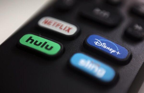 A file photo of logos for streaming services Netflix, Hulu, Disney+, and Sling TV on a remote control. (Jenny Kane/AP)
