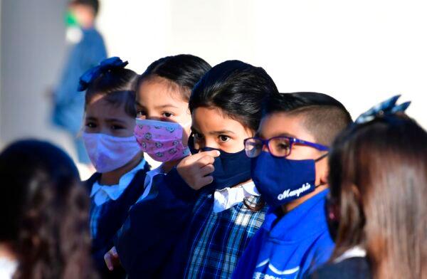 A student adjusts her facemask at St. Joseph Catholic School in La Puente, Calif., on Nov. 16, 2020. (Frederic J. Brown/AFP via Getty Images)