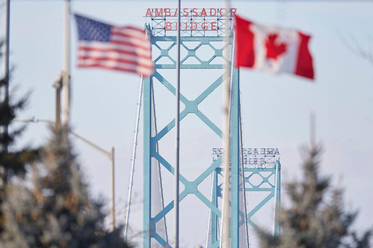 The American and Canadian flags fly at the Ambassador Bridge border crossing in Windsor, Ontario, Canada, on Feb. 9, 2022. (Geoff Robins/AFP via Getty Images)