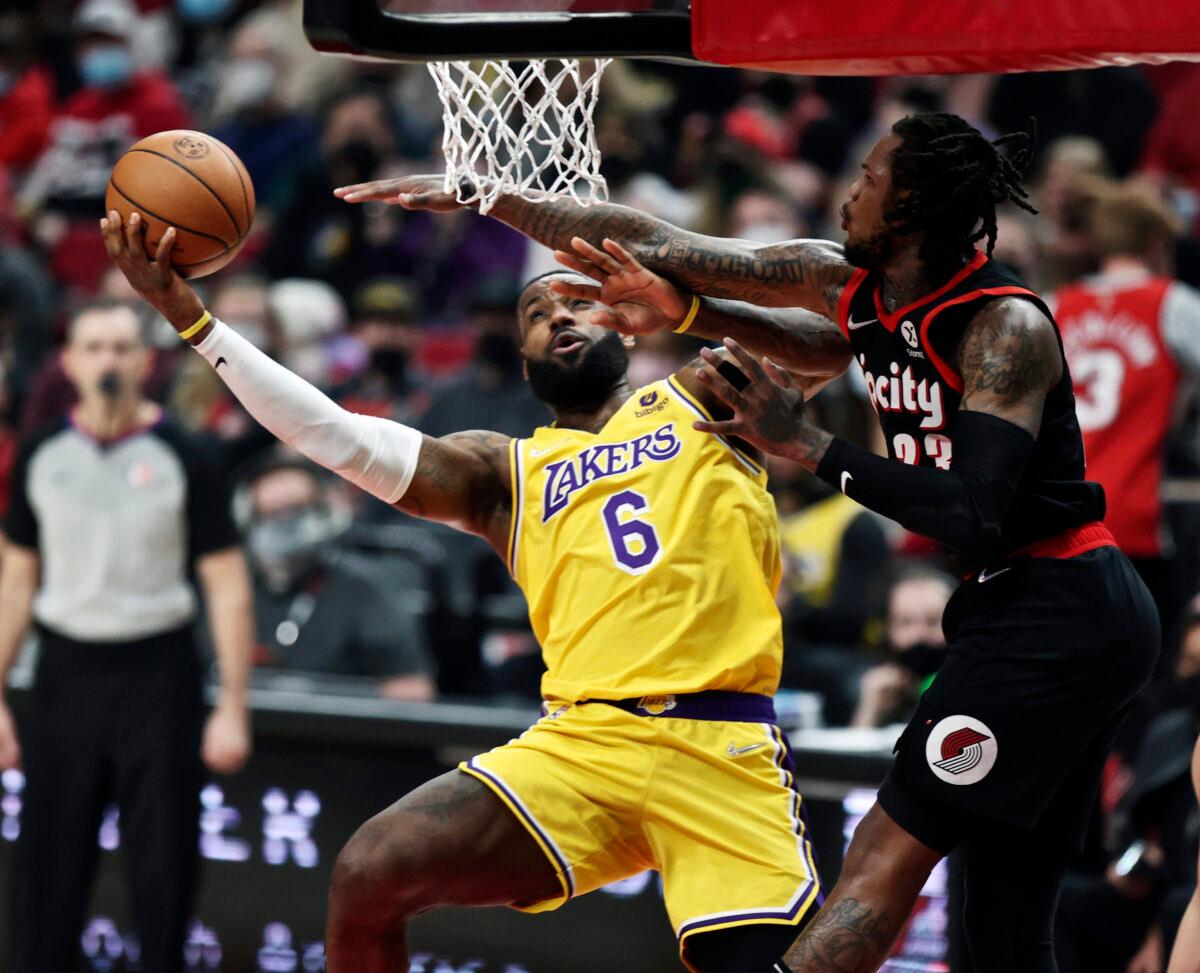 Los Angeles Lakers forward LeBron James (L) shoots as Portland Trail Blazers guard Ben McLemore (R) defends during the first half of an NBA basketball game in Portland, Ore., on Feb. 9, 2022. (Steve Dipaola/AP Photo)