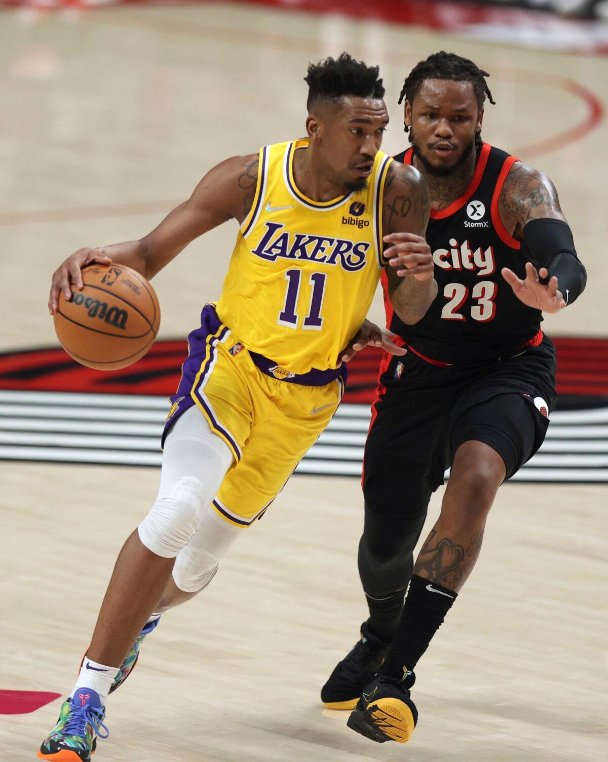 Los Angeles Lakers guard Malik Monk (L) drives as Portland Trail Blazers guard Ben McLemore defends during the first half of an NBA basketball game in Portland, Ore., on Feb. 9, 2022. (Steve Dipaola/AP Photo)