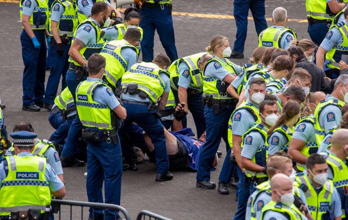 Police arrest people protesting against coronavirus mandates at Parliament in Wellington, New Zealand, on Feb. 10, 2022. (Mark Mitchell/NZ Herald via AP)