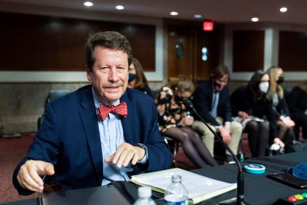 Dr. Robert Califf gathers his documents as the Senate Committee on Health, Education, Labor, and Pension adjourns a hearing on his nomination to be commissioner of the Food and Drug Administration on Capitol Hill on Dec. 14, 2021. (Manuel Balce Ceneta/AP Photo)