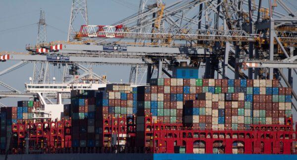 Shipping containers are offloaded from a vessel in the Port of Antwerp, Belgium, on March 23, 2020. (Virginia Mayo/AP Photo)