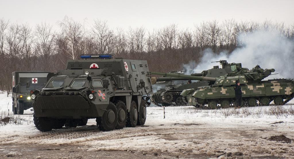 Ukrainian armored vehicles drive during military drills close to Kharkiv, Ukraine, on Feb. 10, 2022. (AP/Andrew Marienko)